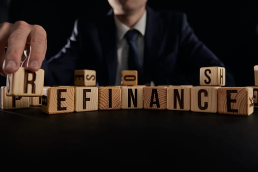 Refinance symbol. Wooden cubes with word refinance