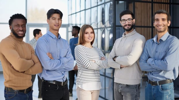 Group of successful businesspeople standing in row and looking at camera at office