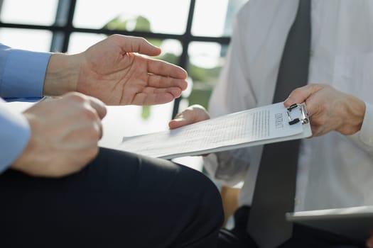 rental contract agreement document to the customer before sign at the office in the background.