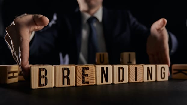 businessman hands holding cubes with branding word