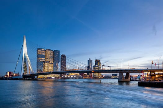 Skyline with the famous Erasmusbrug or Erasmus bridge at twilight in Rotterdam, Netherlands on November 6, 2018