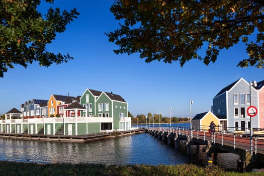 Houten, Netherlands – October 31, 2019: Colorful houses by architect Hans Been surrounded by water of lake De Rietplas in Houten in the Netherlands