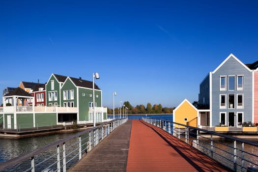 Houten, Netherlands – October 31, 2019: Colorful houses by architect Hans Been surrounded by water of lake De Rietplas in Houten in the Netherlands