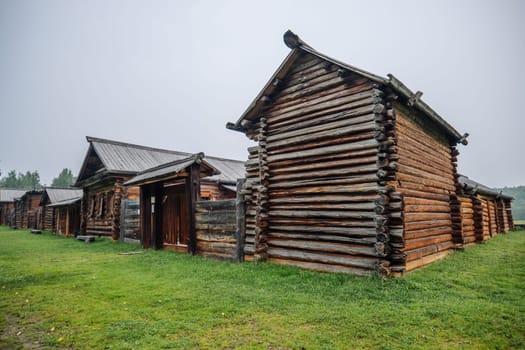 Historical wooden houses revealing traditional russian architectural style within rural open air museum setting, highlighting cultural preservation