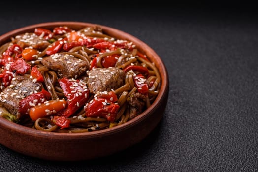 Delicious spicy Asian food soba with buckwheat noodles, beef, vegetables, salt and spices