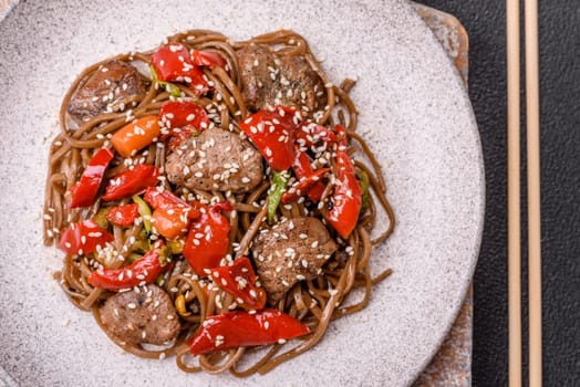 Delicious spicy Asian food soba with buckwheat noodles, beef, vegetables, salt and spices