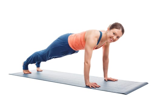 Smiling woman doing Ashtanga Vinyasa yoga asana Utthita chaturanga dandasana (or phalakasana) - extended four-limbed posture plank pose isolated on white background