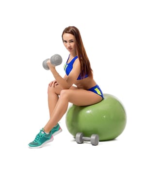 Image of cute female athlete exercising with dumbbells