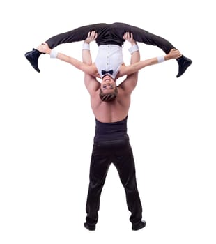 Cheerful female acrobat posing with her partner, isolated on white