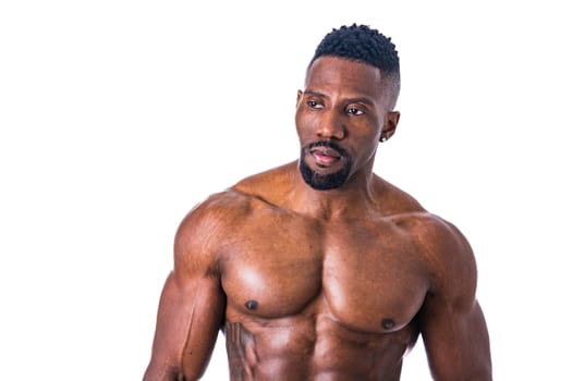 A shirtless male bodybuilder posing for a picture. Photo of a shirtless muscular black man posing for a picture in studio on neutral background