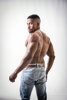 A shirtless man posing for a picture. Photo of a strong and confident shirtless African American man showcasing his muscular physique