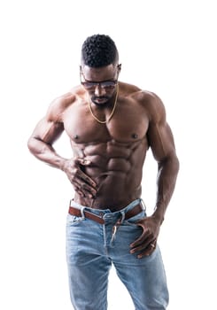 A shirtless male bodybuilder posing for a picture. Photo of a shirtless muscular black man posing for a picture in studio on neutral background