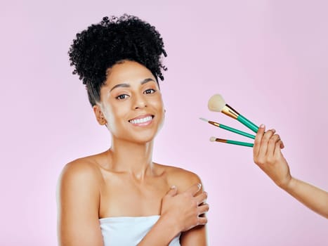 Makeup brush, smile and studio portrait of woman with tools choice for skincare glow, routine treatment or wellness self care. Beauty spa cosmetics, happiness and model makeover on pink background.