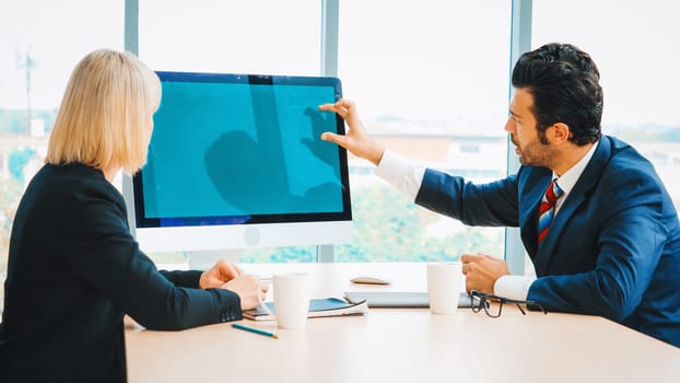 Business people in the conference room with green screen chroma key TV or computer on the office table. Diverse group of businessman and businesswoman in meeting on video conference call . Jivy