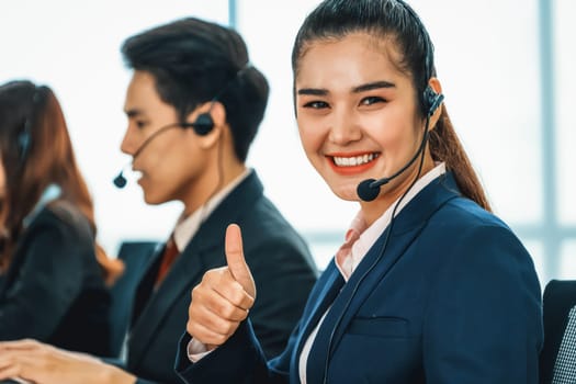 Business people wearing headset working in office to support remote customer or colleague. Call center, telemarketing, customer support agent provide service on telephone video conference call. Jivy