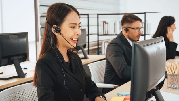 Business people wearing headset working in office to support remote customer or colleague. Call center, telemarketing, customer support agent provide service on telephone video conference call. Jivy