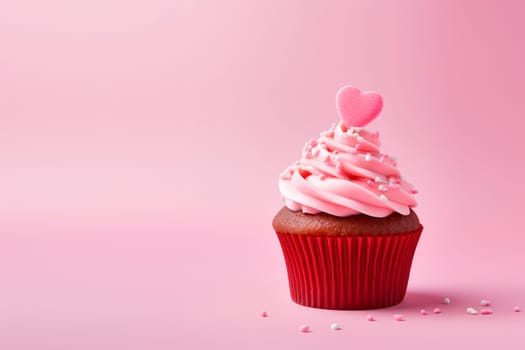 A beautiful dessert for Valentine's Day. Cupcake on a pink background. Cupcake decorated with cream and hearts. The concept of celebrating February 14.