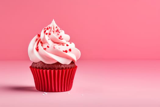 A beautiful dessert for Valentine's Day. Cupcake on a pink background. Cupcake decorated with cream and hearts. The concept of celebrating February 14.