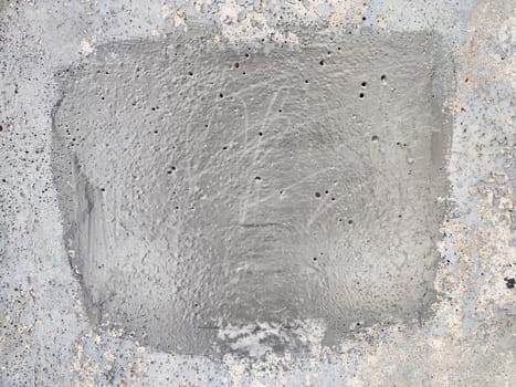 A smooth, even gray surface with visible texturing is prepared for further work at a construction site, showcasing craftsmanship and precision.