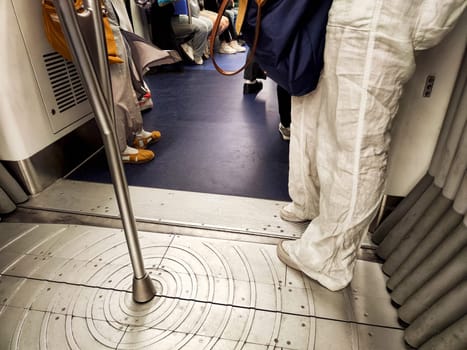 Hong Kong, China - April 09, 2024 - Passengers ride the subway in Hong Kong, surrounded by a mix of attitudes and activities during busy travel times.