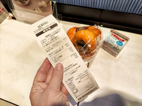 Osaka, Japan - October 26, 2024: Receipt from a convenience store in Osaka featuring a variety of products, including snacks and groceries purchased on a recent visit.