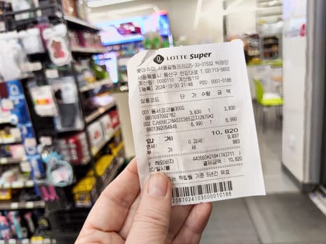 Seoul, Korea - November 01, 2024: Receipt displays a list of products bought in a Seoul store, highlighting items and total cost at the time of purchase.