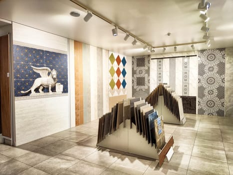 Kirov, Russia - November 27, 2024 - Customers browse through distinctive ceramic tiles in a well-lit showroom featuring various colors and patterns.