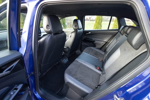 Leather car passenger seat. Control unit with electric seat adjustment media system for rear passengers in luxury car. Car interior detail. Rear leather passenger seats in modern lux electric car.