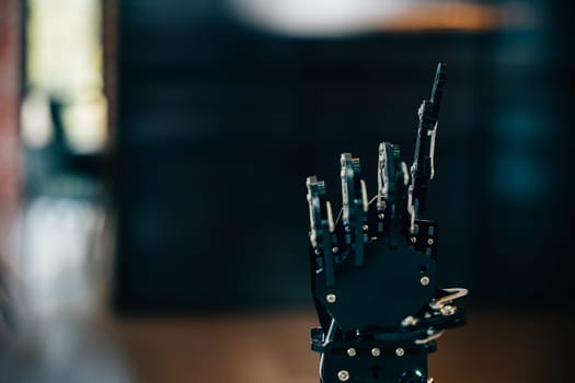 Demonstrating futuristic design a black real robot hand contacts a table. Symbolizing artificial intelligence evolution and technological innovation in modern robotics.