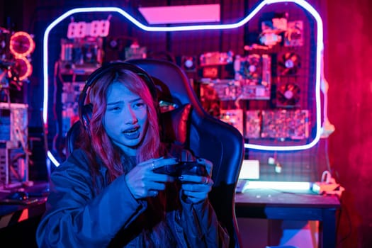 Woman wear gaming headphones playing esports games console gaming room, Gamer using joystick controller for race tournament plays online video game with computer neon lights