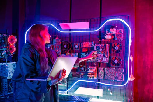 Software engineer typing coding in laptop computer at data center, Hacker woman is sitting at a desk with a laptop service in server room, Thinking and solve problems, Cyber security