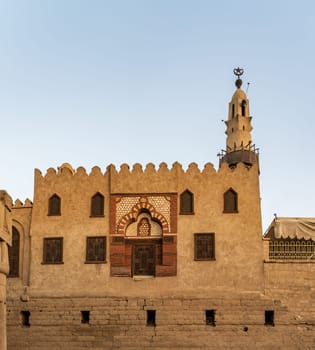 Abu Haggag mosque with a detailed entrance and a tall minaret under a clear sky and built inside the Luxor temple