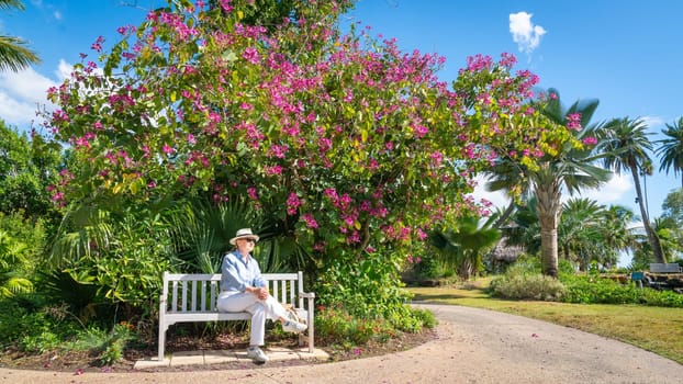 Woman taking rest on a bench in a park in Florida on а beautiful sunny day