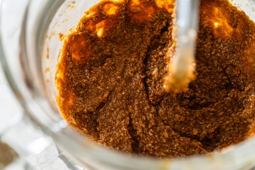 The mixer combines molasses, eggs, butter, and sugar, creating a smooth and rich base for Chocolate Gingerbread Cookie Dough. This mixture adds deep flavor and moisture to the dough.