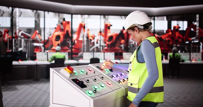 Worker In Automotive Car Factory Using Control Panel