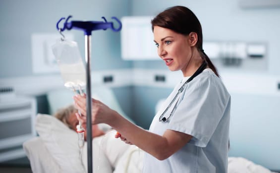 Nurse Or Doctor Examines Patient IV Drip