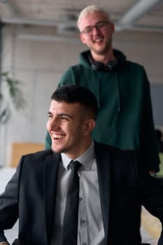 Employee Entertaining Director in a Wheelchair While Rolling Through the Office with Laughter and Joy