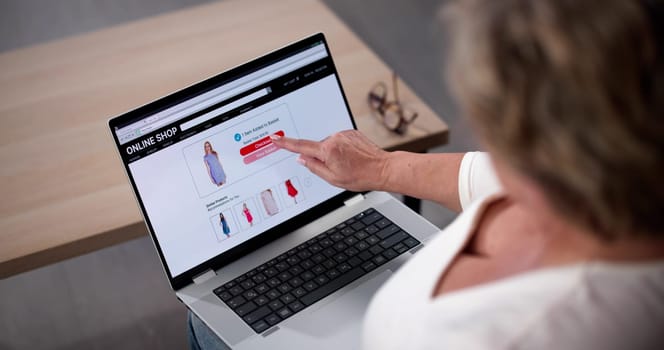 Woman Sitting On Couch Doing Online Shopping On Laptop