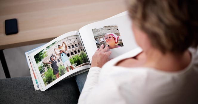Woman Looking At Photo Album Or Photobook