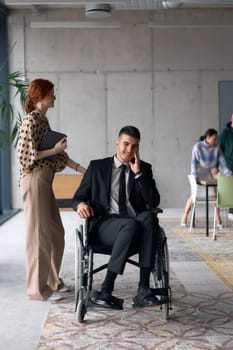 A business director in a wheelchair moves confidently through a modern office alongside his colleague, showcasing teamwork, leadership, and inclusivity in the workplace