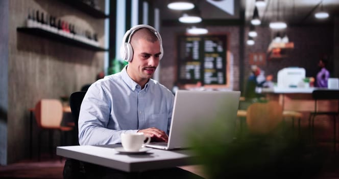 Man Using Business Laptop Online With Headset