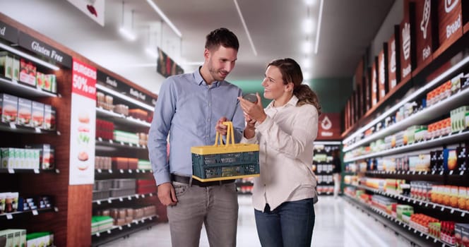 Couple Shopping At Supermarket Or Grocery Market