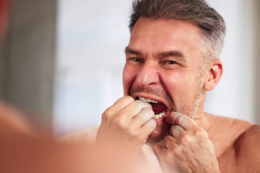 Man Flossing Teeth. Cleaning Tooth Close Up
