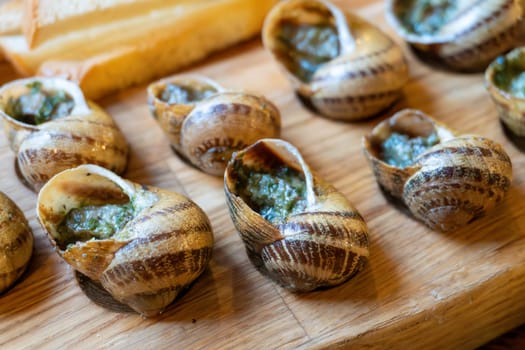 Delicious escargot dish with garlic butter sauce and fresh baguette.