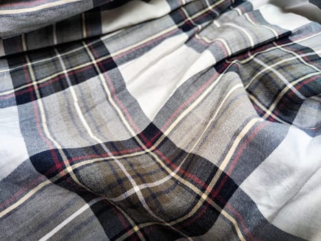 Detailed plaid fabric showcasing a combination of gray, white, and burgundy, ideal for fashion design, upholstery, or artistic uses.