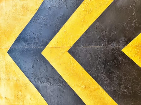 Bright yellow and black chevron pattern on a textured surface offers ample space for text, enhancing creativity and design options.