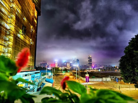 Hong Kong, China - April 06, 2024 - Vibrant city lights adorn Hong Kong's skyline at night, showcasing tall skyscrapers and urban life seen from a nearby viewpoint.