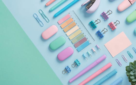 Stationery with markers, felt-tip pens, paper clips, erasers, stapler, pastel-colored stickers neatly arranged on a light blue and mint green background. Space for text.