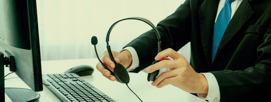 Business people wearing headset working in office to support remote customer or colleague. Call center, telemarketing, customer support agent provide service on telephone video conference oratory call