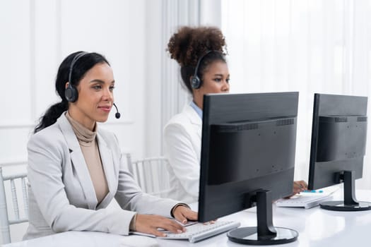 Business people wearing headset working in office to support remote customer or colleague. Call center, telemarketing, customer support agent provide service on telephone video conference call crucial